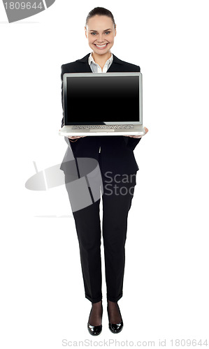 Image of Full length portrait of woman presenting new laptop