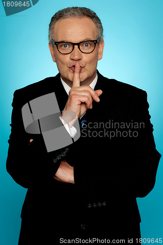 Image of Silence please, businessman looking at you