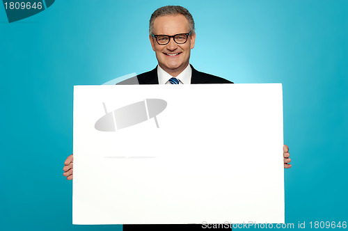 Image of Business representative holding blank ad board