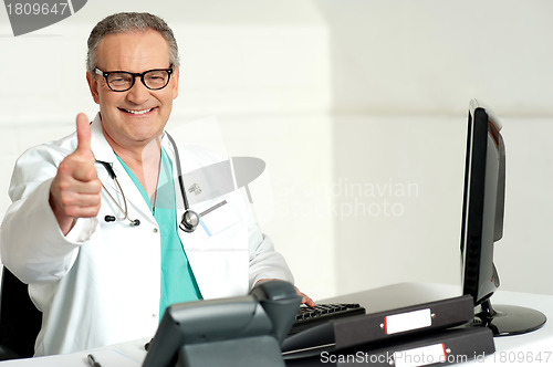 Image of Smiling doctor gesturing thumbs up to camera