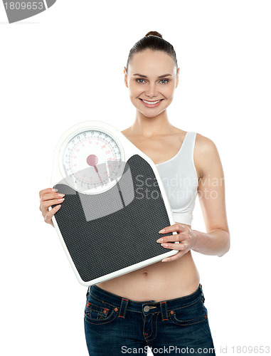Image of Healthy young woman with a weighing scale