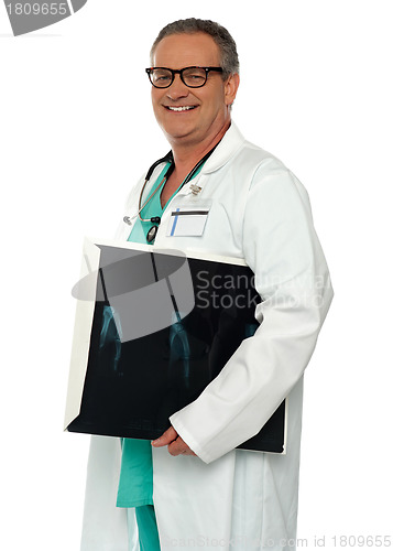 Image of Smiling doctor carrying x-ray report of hand bone