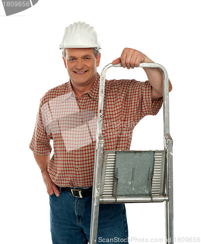 Image of Smiling aged worker posing with ladder
