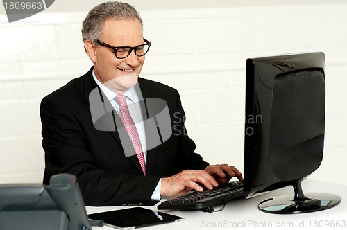 Image of Casual businessman typing on keyboard