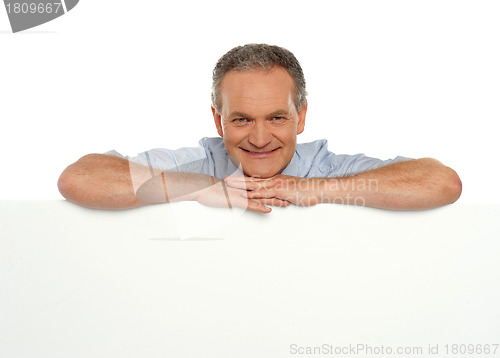 Image of Smiling man behind blank white banner ad