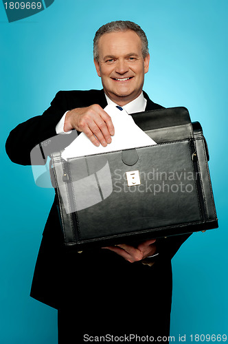 Image of Businessman keeping documents safely