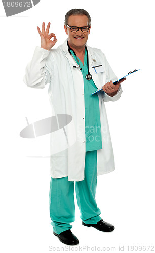 Image of Male physician with excellent gesture holding clipboard