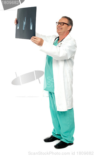 Image of Full length portrait of senior surgeon holding x-ray