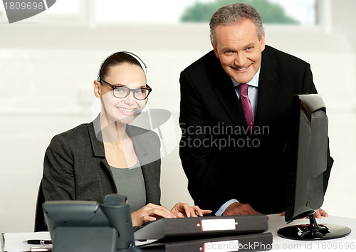 Image of Cheerful corporate people at work in office