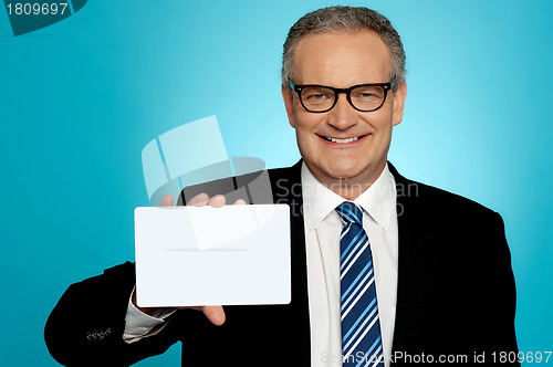 Image of Businessman in glasses showing placard