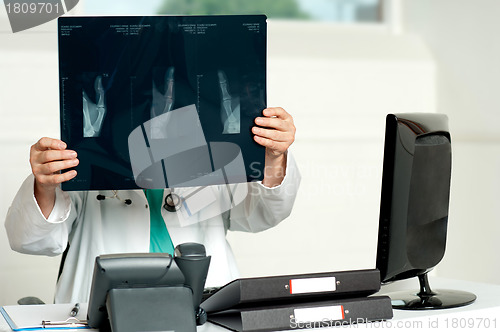 Image of Male surgeon holding x-ray