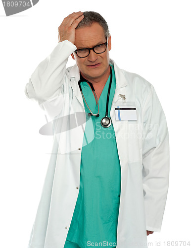 Image of Senior physician having headache