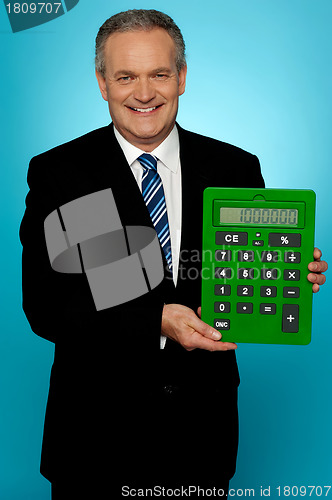 Image of Senior manager showing big green calculator