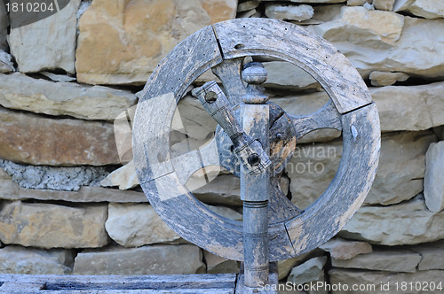 Image of Retro Spinning Wheel Against Stone Wall Background