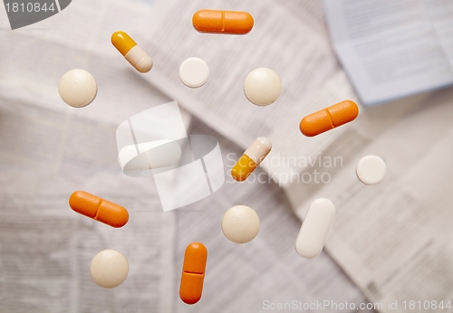 Image of Pills on a glass plate over package leaflets