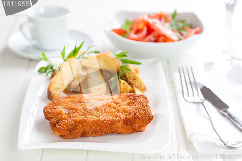 Image of Schnitzel with wedges and tomato salad