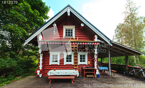 Image of Red Log Cabin n the Forest