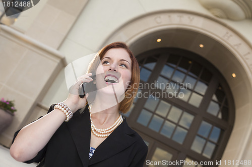 Image of Happy Businesswoman On Cell Phone in Front of City Hall
