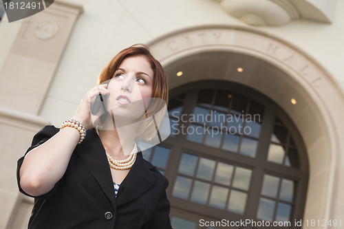Image of Young Businesswoman On Cell Phone in Front of City Hall