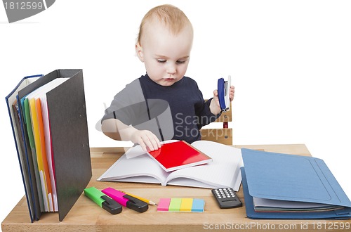 Image of young child at writing desk