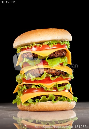 Image of Tasty and appetizing hamburger on a dark