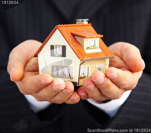 Image of Hand of the businessman with the house