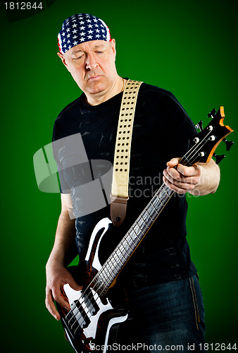 Image of man with a guitar, bass player