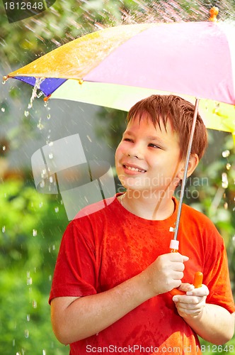 Image of boy under an umbrella during a rain