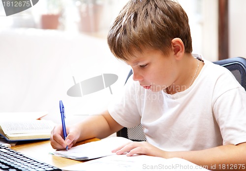 Image of boy behind a desk