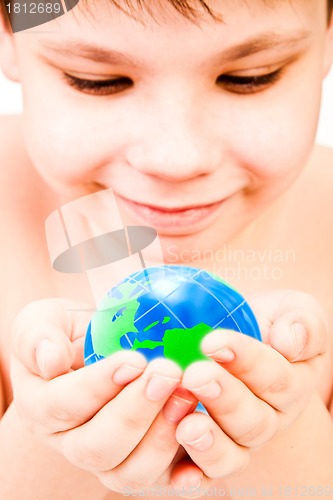 Image of boy holds globe in hands