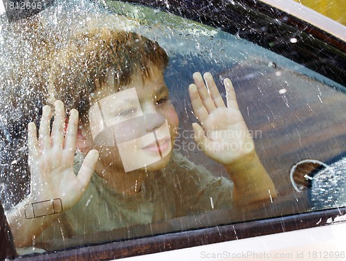 Image of child and window on a wet rainy day