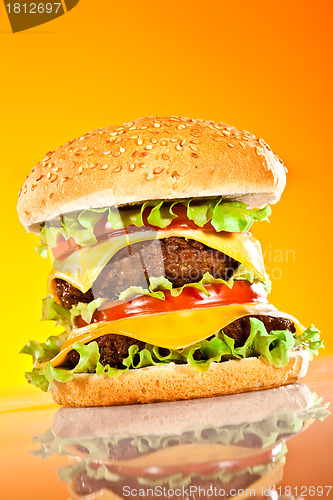 Image of Tasty and appetizing hamburger on a yellow