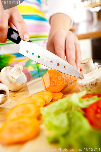 Image of Woman's hands cutting vegetables