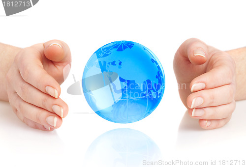 Image of hand of the person holds globe