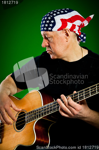 Image of man with a guitar, bass player