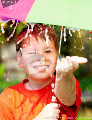 Image of boy under an umbrella during a rain