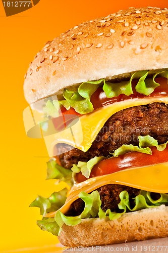 Image of Tasty and appetizing hamburger on a yellow