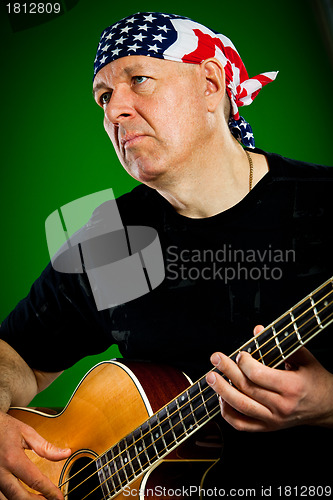 Image of man with a guitar, bass player