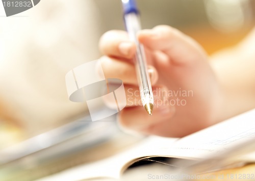 Image of hand of the person holds pen