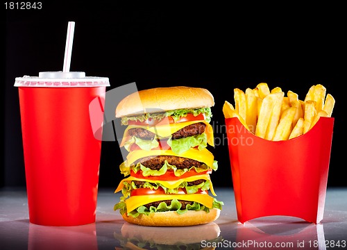 Image of Tasty hamburger and french fries on a dark