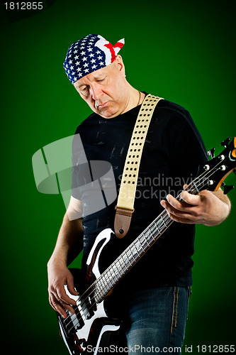 Image of man with a guitar, bass player