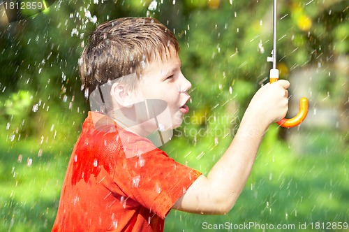Image of boy under an umbrella during a rain