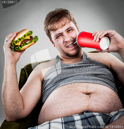 Image of fat man eating hamburger