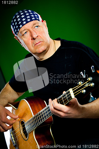 Image of man with a guitar, bass player