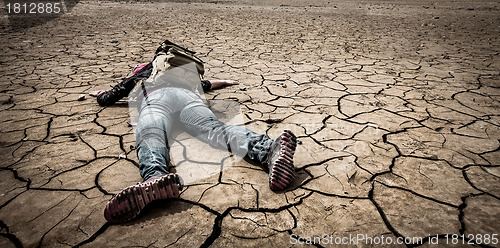 Image of person lays on the dried ground