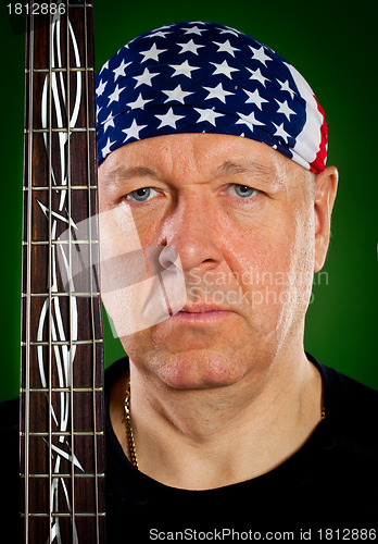 Image of man with a guitar, bass player