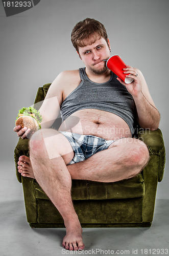 Image of fat man eating hamburger