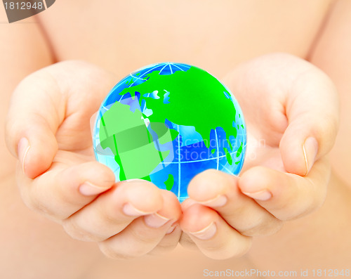 Image of hand of the person holds globe