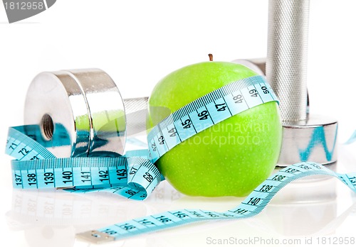 Image of Dumbbells and apple. A healthy way of life