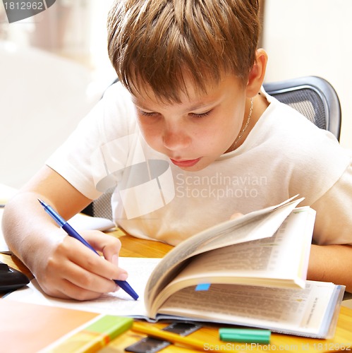 Image of boy behind a desk